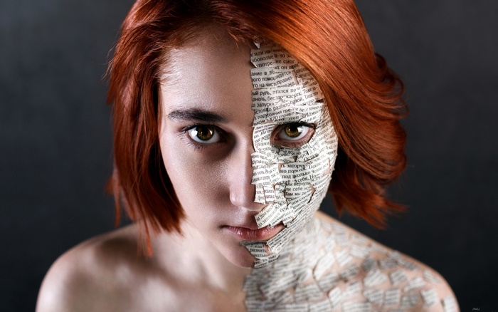 Woman with newspaper on face