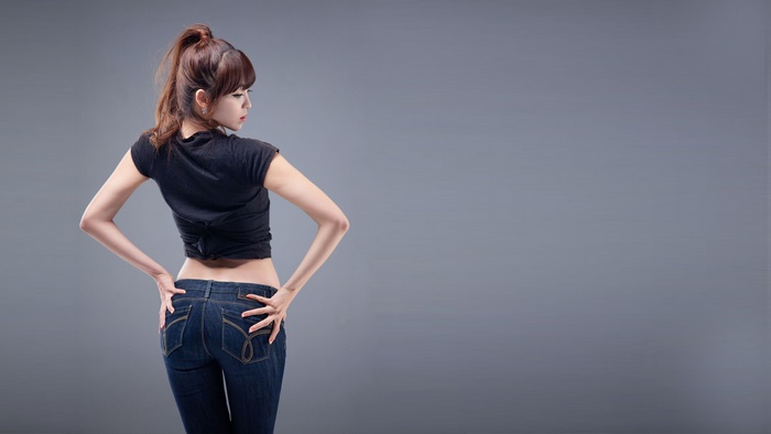 Asian woman in black crop top and jeans