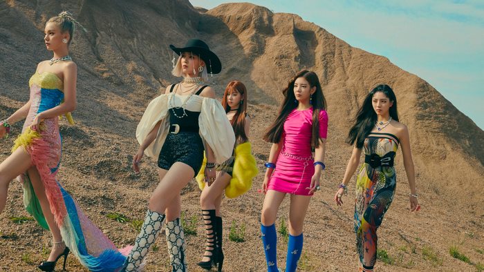 ITZY members in a desert landscape