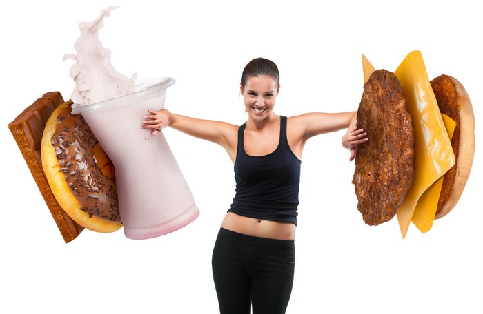 Woman holding a milkshake and a hamburger
