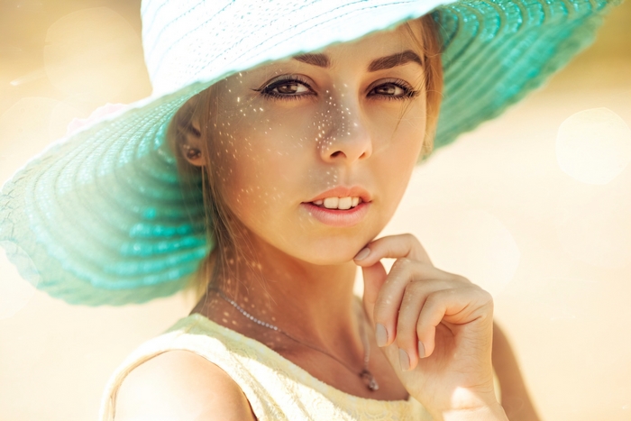 Woman wearing a large blue sun hat