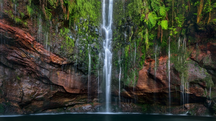 Waterfall cascading over mossy rocks