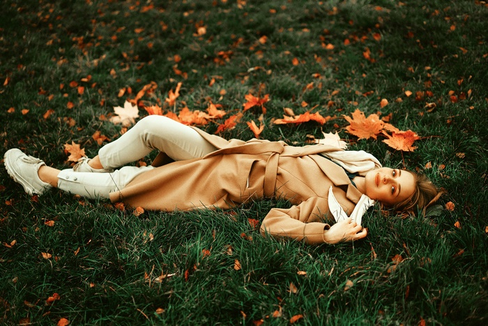 Woman Lying Down in Autumn Coat
