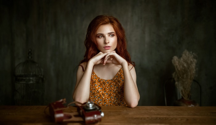 Redhead woman with vintage camera