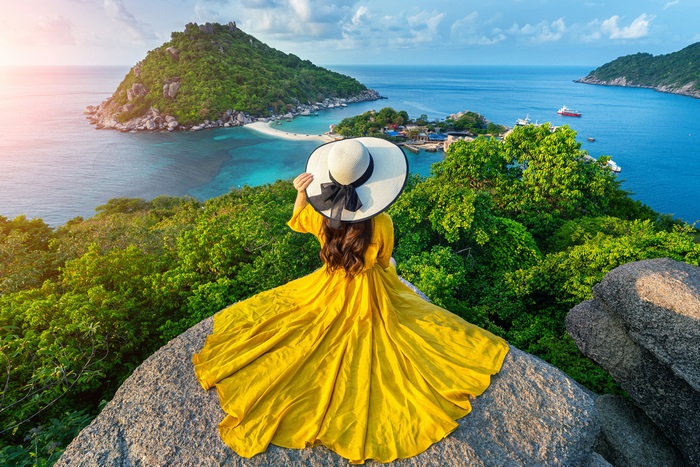 Woman in Yellow Dress on Rock Overlooking Thailand Coast