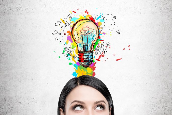 Woman with Colorful Idea Lightbulb and Symbols