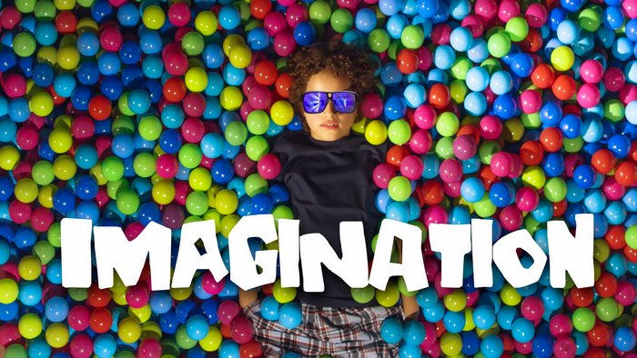 Child in Ball Pit with "IMAGINATION" Text