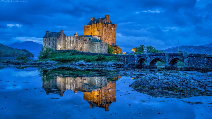 Eilean Donan Castle reflection over water at dusk