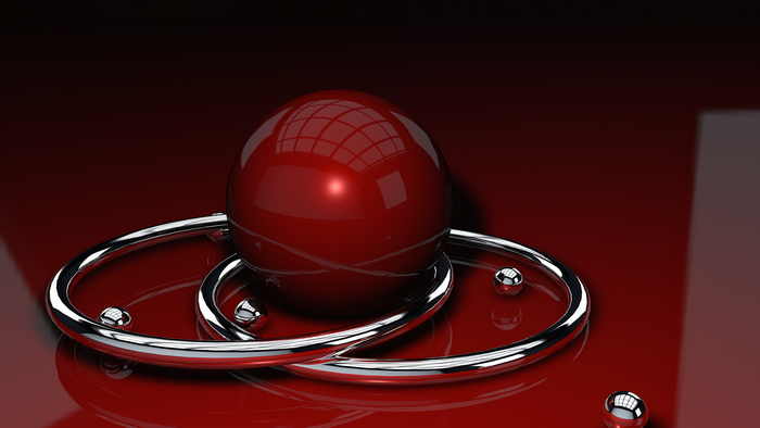 Red sphere and chrome rings on a reflective surface