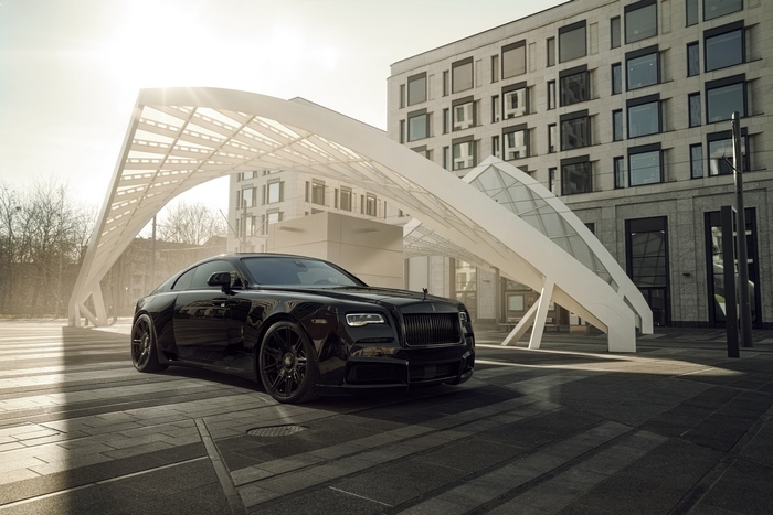 Black Rolls-Royce Wraith parked near modern architecture
