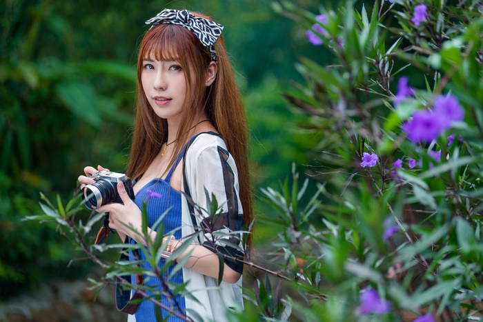 Asian Woman with Camera and Purple Flowers