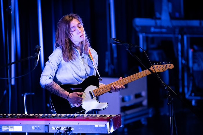 Julien Baker plays guitar on stage