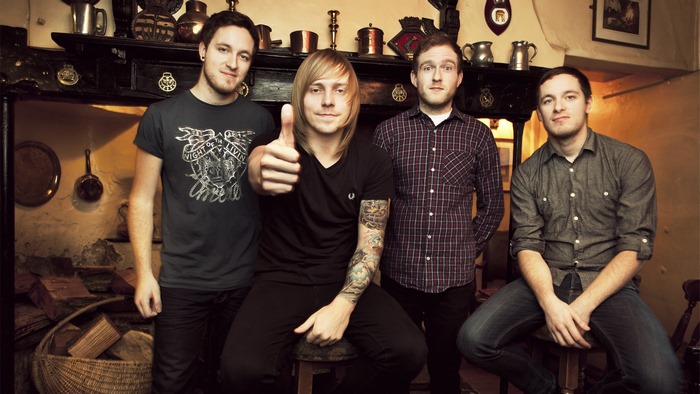 Architects band members posing in a pub