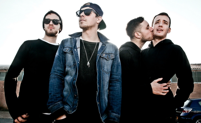 Four men posing for a photo