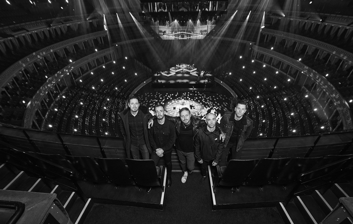 Architects band posing in a concert hall