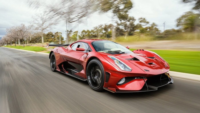 Red Brabham BT62R Driving on a Road