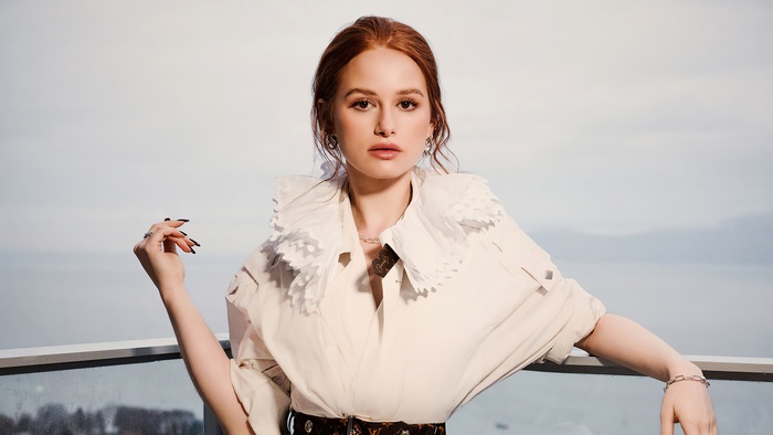 Madelaine Petsch posing outdoors with a scenic background