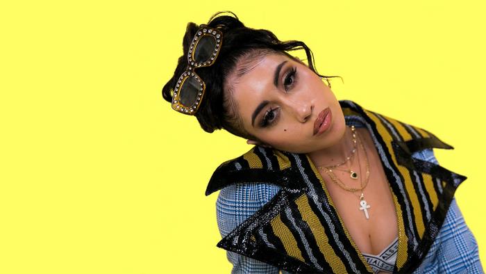 Kali Uchis with sunglasses and necklaces