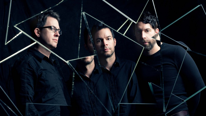 Chevelle band members reflected in broken glass