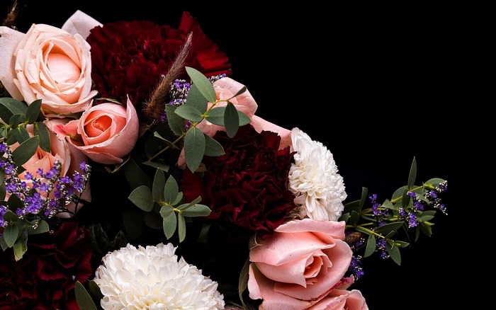 A bouquet of roses and carnations