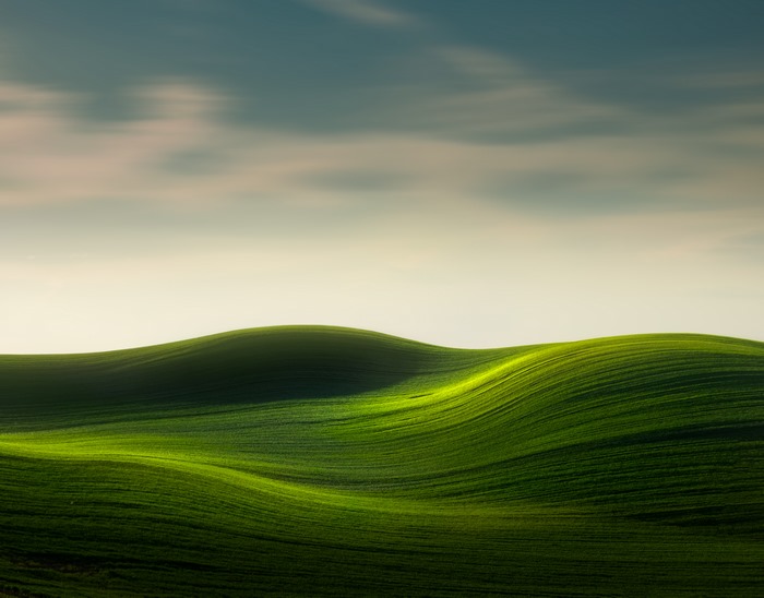 Rolling Green Hills Under a Cloudy Sky