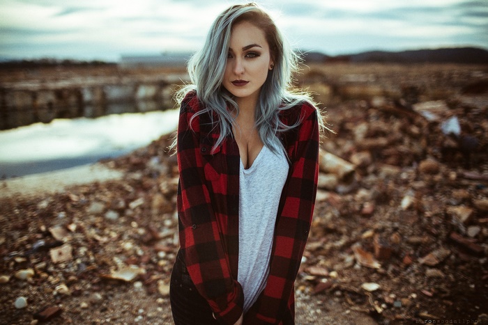 Woman with blue hair in a plaid shirt