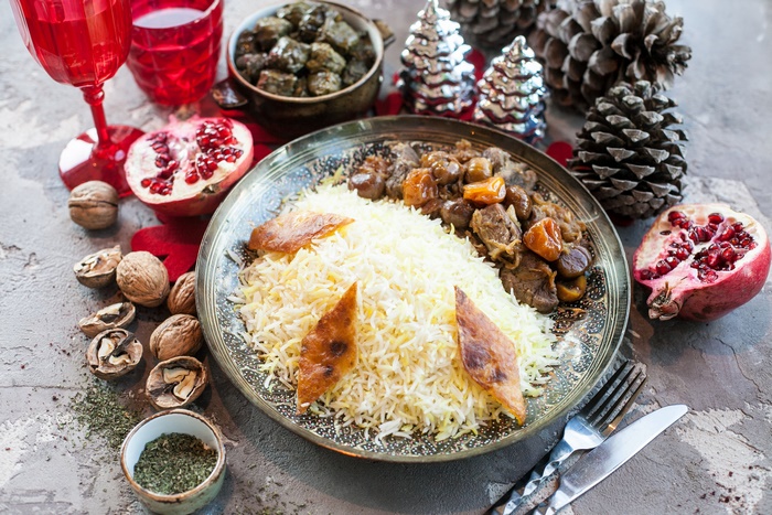 Rice and meat dish with pomegranates and walnuts