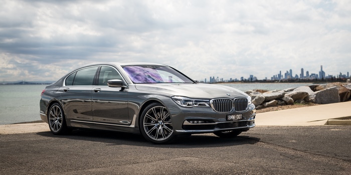 Silver BMW 7 Series parked by the water