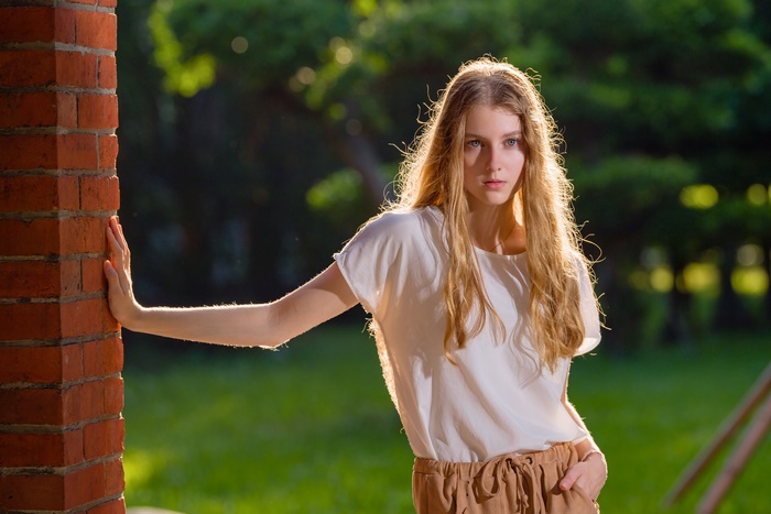 Blonde Woman in White Shirt and Brown Pants