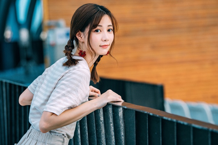 Asian Woman with Braids and Flower Earrings