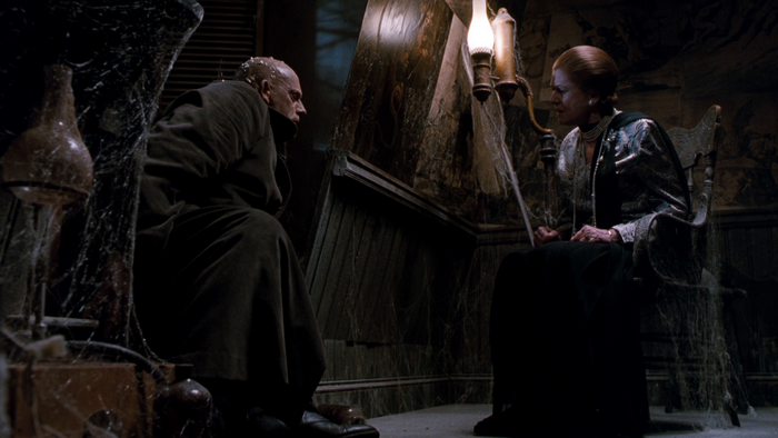 Uncle Fester and Abigail Craven in a dark room