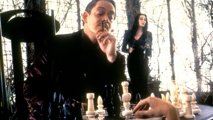 Gomez and Morticia Addams playing chess