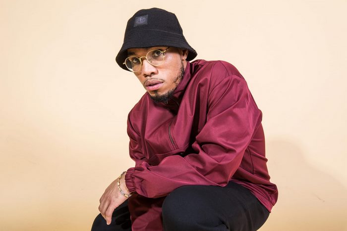 Anderson .Paak wearing a bucket hat and glasses