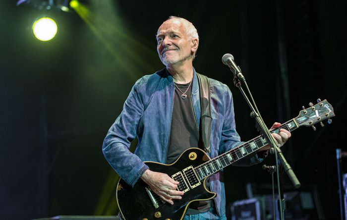 Peter Frampton playing guitar on stage