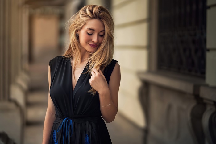 Woman in a black dress with blonde hair
