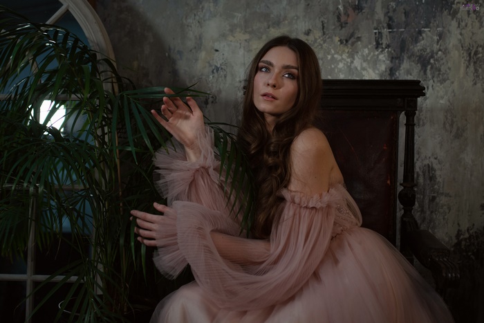 Woman with long brown hair in a pink dress