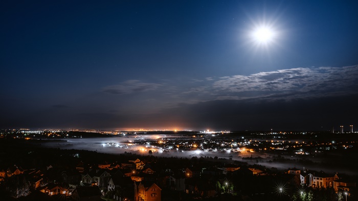 Night view of a town with fog and moon
