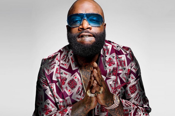 Rick Ross wearing a suit with playing card patterns