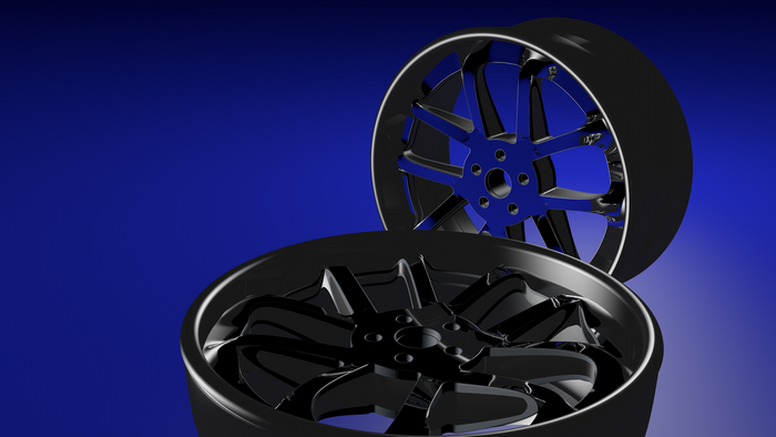 Two 3D rendered car wheels on a blue background
