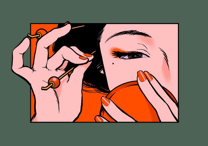 Woman applying makeup with skewers
