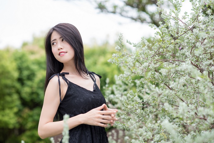 Asian woman with black hair in a black dress