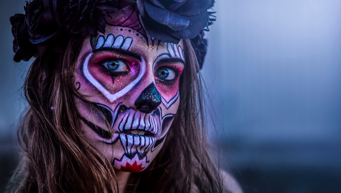 Woman with Sugar Skull Face Paint and Flower Crown
