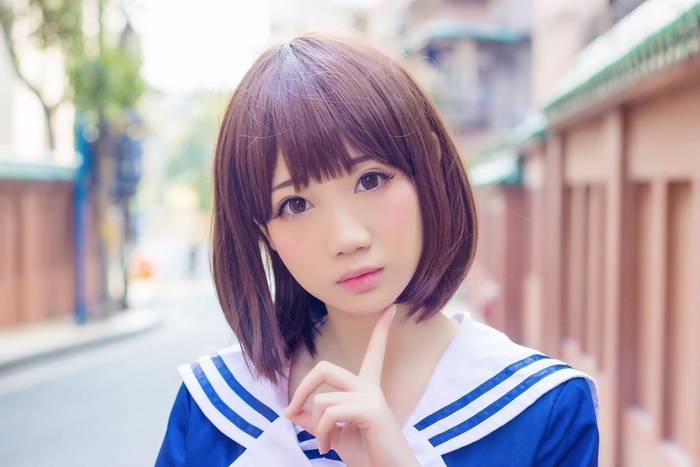 Asian woman with short brown hair in a sailor uniform
