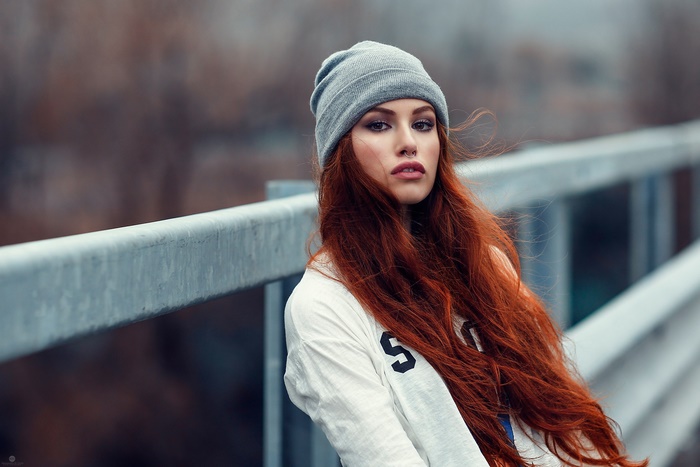 Woman with long red hair wearing a beanie