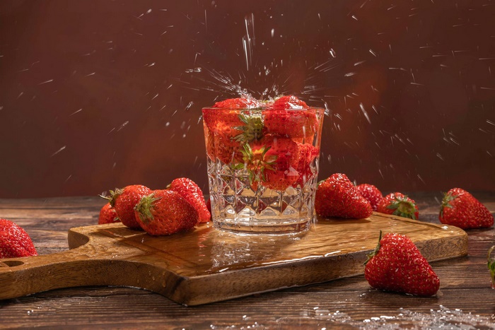 Strawberries in a glass with water splash