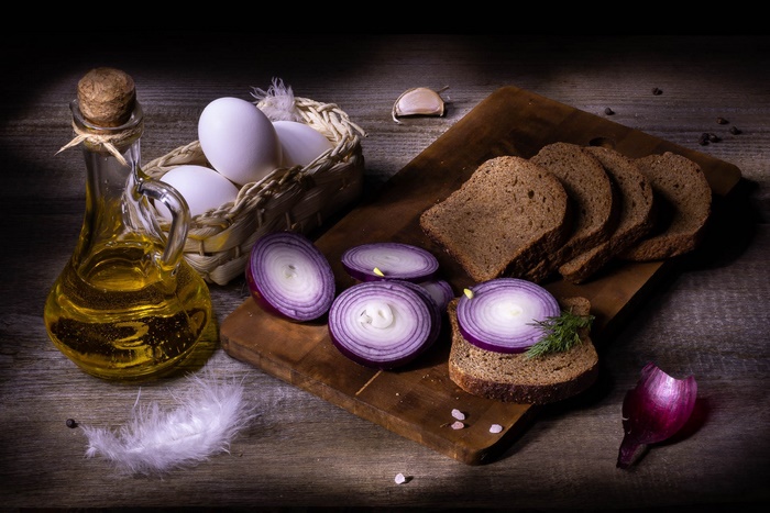 Still life with eggs, bread, oil, and onions