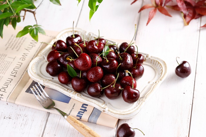 Fresh Cherries on a Decorative Plate with Fork