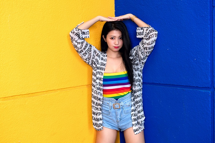 Woman in Rainbow Top and Denim Shorts