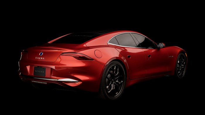 Red Karma Revero GT car on a black background