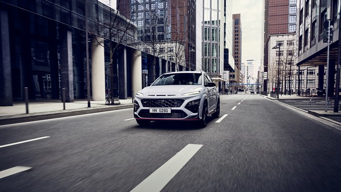 White Hyundai Kona N driving on a city street